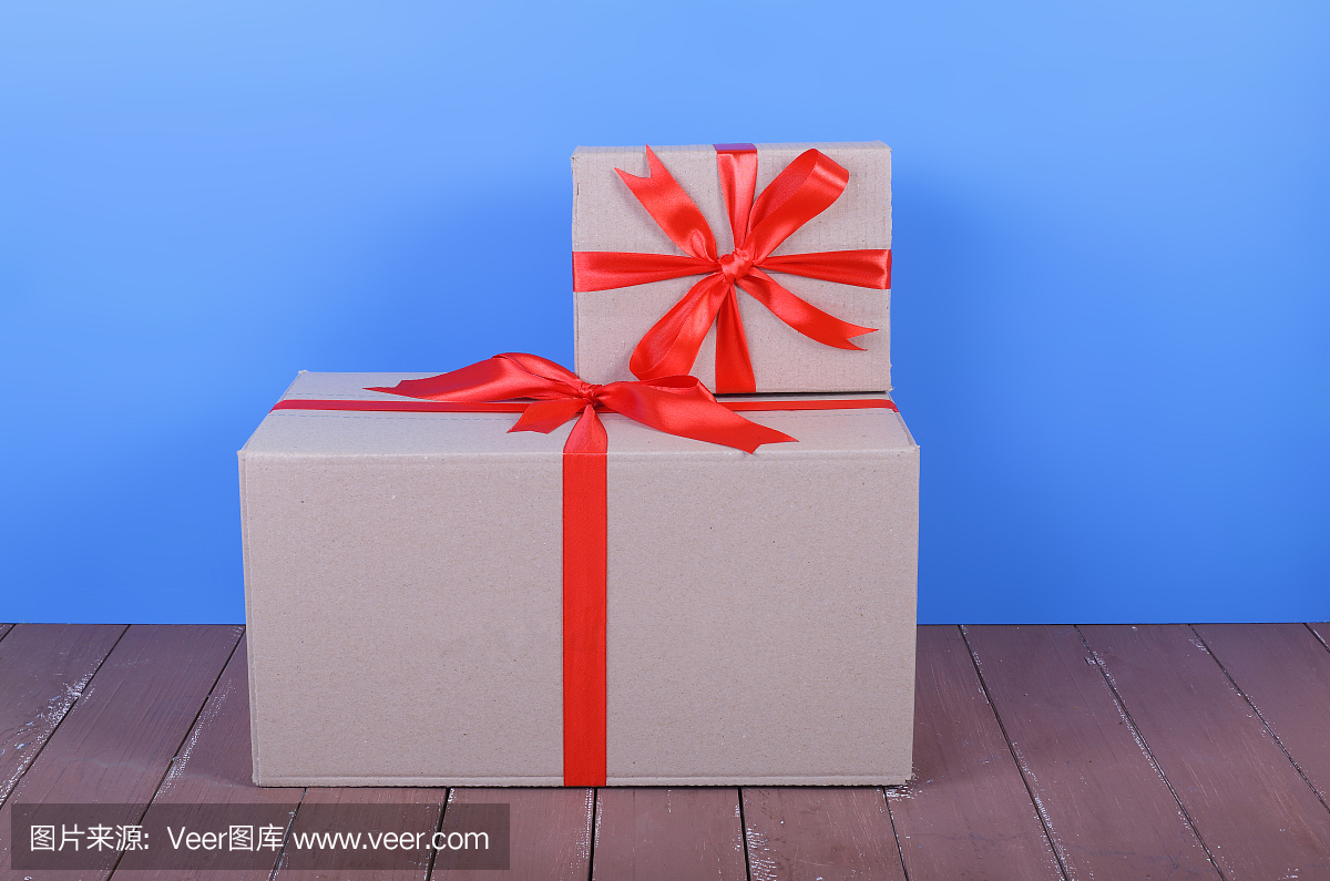 邮资和包装递送服务-大的和小的包裹用一个红色的蝴蝶结系起来